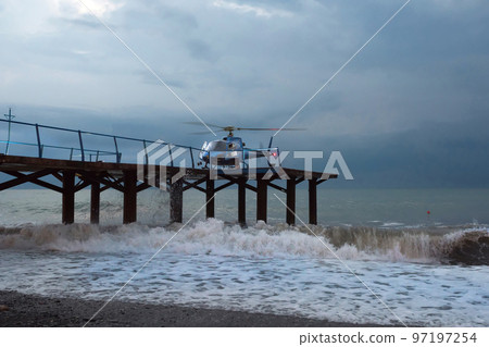 A helicopter lands people, during a gale. Marine gale A helicopter lands people, during a gale. Marine gale 97197254