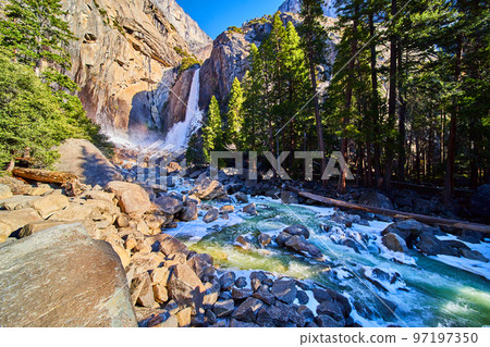 Yosemite Lower Falls in early morning with frosted rocks and ice cold river 97197350