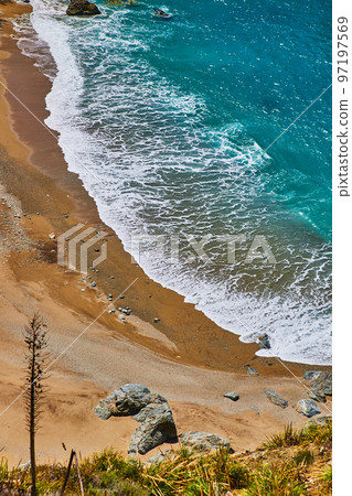 View from above of beach with beautiful blue ocean waves crashing View from above of beach with beautiful blue ocean waves crashing 97197569