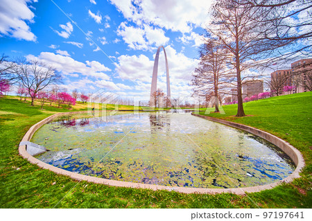 Vibrant spring morning on pond with algae and Gateway Arch of St. Louis in background Vibrant spring morning on pond with algae and Gateway Arch of St. Louis in background 97197641