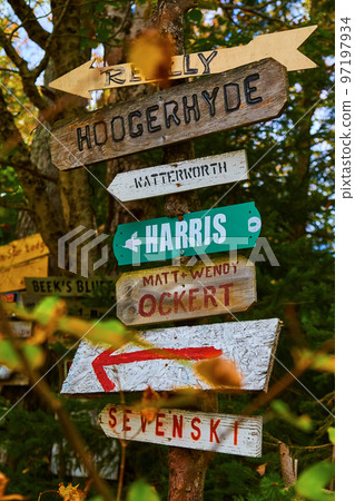Signs in a forest pointing to different locations Signs in a forest pointing to different locations 97197934