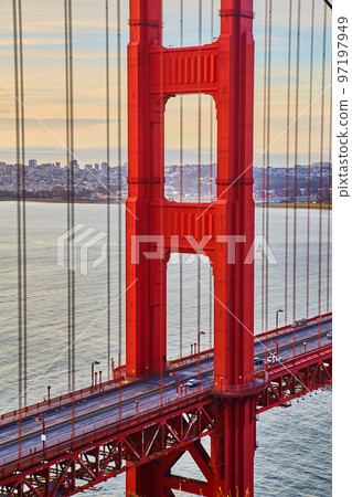 Morning traffic crossing vibrant red Golden Gate Bridge in San Francisco Morning traffic crossing vibrant red Golden Gate Bridge in San Francisco 97197949