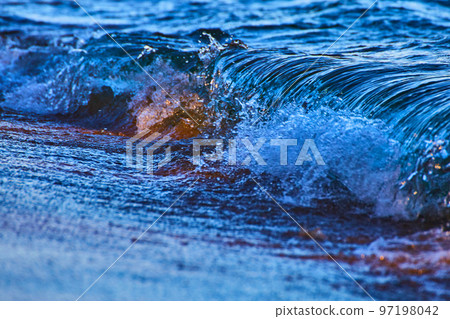 Choppy wave breaks during a rainstorm in deep blues and violets Choppy wave breaks during a rainstorm in deep blues and violets 97198042