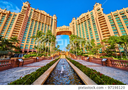 Peaceful tropics gardens with resort architecture and palm trees 97198120