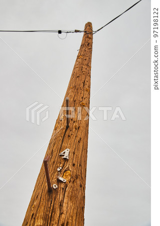 Looking up at telephone pole power with number four 97198122