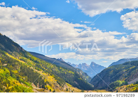 Bottom of valley surrounded by vast mountains 97198289