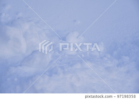 Snow surface with lumps and snowdrifts in winter. Winter snow field surface. 97198358