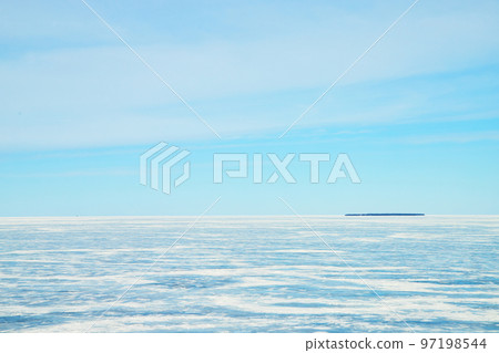 Ice formations on frozen lake from Mackinaw bridge 97198544