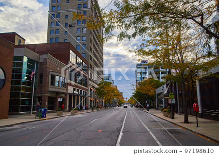 Downtown city road with businesses and traffic 97198610