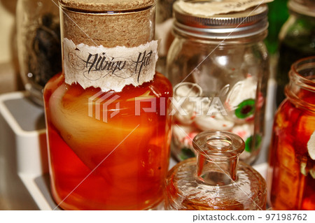 Halloween decorations rat suspended in red liquid next to a mason jar filled with eyeballs 97198762