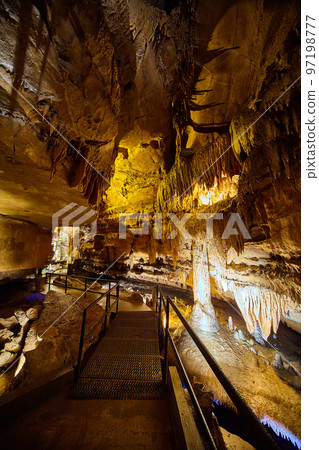 Vertical guided tour path through Indiana Kentucky midwest America cave with stalagmites and stalactites 97198777
