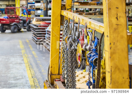 Detail of manufacturing accessories and forklift in background 97198984