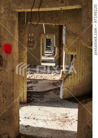 Perspective shot of infinite doorways in an abandoned grain elevator with an ominous feel 97199220