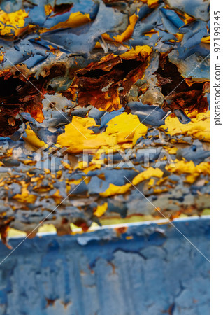 Yellow paint peeling off an abandoned old wall at a closed amusement park Yellow paint peeling off an abandoned old wall at a closed amusement park 97199245