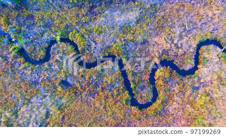 Winding river from above with a fall forest around it Winding river from above with a fall forest around it 97199269