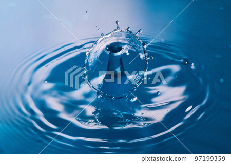 Two water drops colliding on clean blue surface Two water drops colliding on clean blue surface 97199359