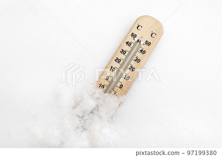 Thermometer on snow shows low temperatures - zero. Low