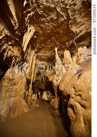 Cave pathyway with stalagmites and stalactites Cave pathyway with stalagmites and stalactites 97199534