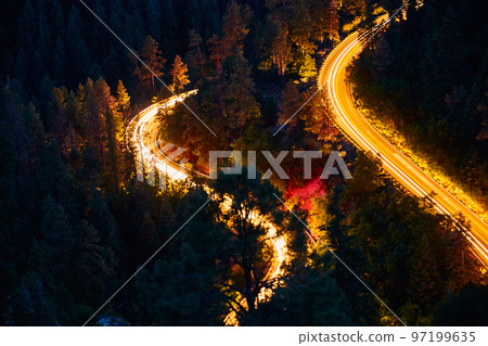 Night landscape of mountain roads and blur of cars driving Night landscape of mountain roads and blur of cars driving 97199635