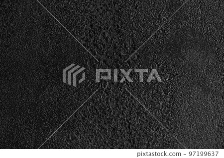 Close up of dark grey, grainy surface for modern, unusual background design. Rough texture of black covering backdrop. Concept of textures and background. Close up of dark grey, grainy surface for modern, unusual background design. Rough texture of black covering backdrop. Concept of textures and background. 97199637