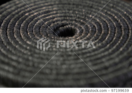 Twisted, coiled natural dark jute pattern as background. Close up of textured backdrop of tight rolled up grey rope, with void in middle, with blurring. Concept of textures and backgrounds. Twisted, coiled natural dark jute pattern as background. Close up of textured backdrop of tight rolled up grey rope, with void in middle, with blurring. Concept of textures and backgrounds. 97199639