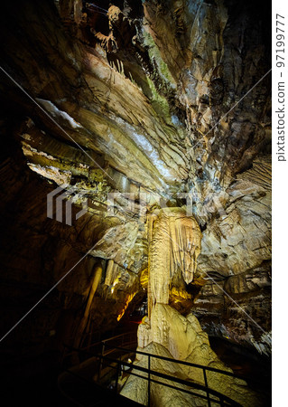 Cave formations on walkway underground with stalagmites and stalactites 97199777