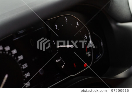 Modern car dashboard with speedometer, tachometer. Car dashboard. Car dashboard details. Modern car interior. The speedometer of a modern Modern car dashboard with speedometer, tachometer. Car dashboard. Car dashboard details. Modern car interior. The speedometer of a modern 97200916