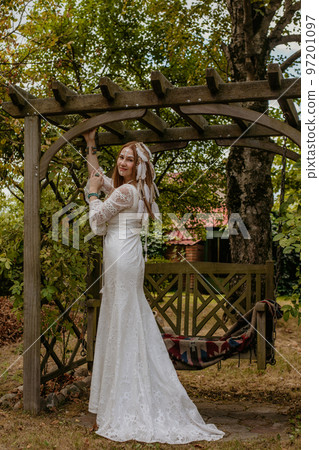 Beautiful young bride in a boho dress. Beautiful young bride in a boho dress. 97201097