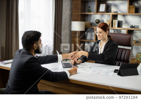 Happy male job seeker shake hand of female hr manager being accepted on vacant place. 97201184