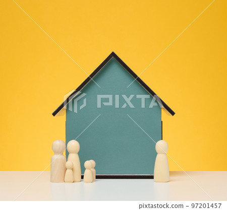 Wooden house and miniature figurines of a family and a realtor on a yellow background. Wooden house and miniature figurines of a family and a realtor on a yellow background. 97201457