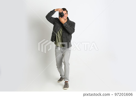 Professional photographer working on white background in studio 97201606