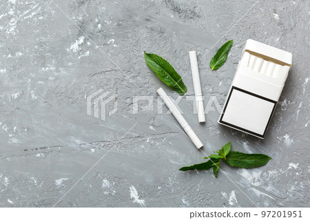Pack of menthol cigarettes and fresh mint on colored table, Menthol cigarettes top view flat lay 97201951