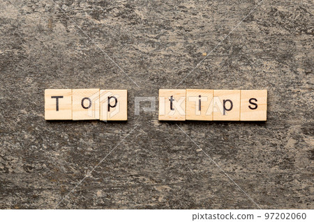 Top tips word written on wood block. Top tips text on cement table for your desing, Top view concept Top tips word written on wood block. Top tips text on cement table for your desing, Top view concept 97202060