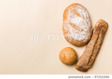 Homemade natural breads. Different kinds of fresh bread as background, top view with copy space Homemade natural breads. Different kinds of fresh bread as background, top view with copy space 97202080