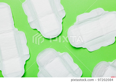 Women hygiene products or sanitary pad on colored background. Pastel color. Closeup. Empty place for text. Female daily hygiene 97202084