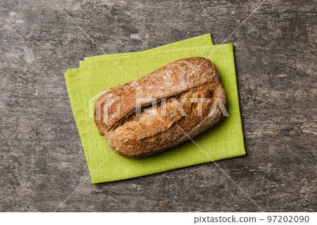 Fresh Homemade Whole Wheat Bread. bread on napkin on rustic background, fresh bread top view 97202090