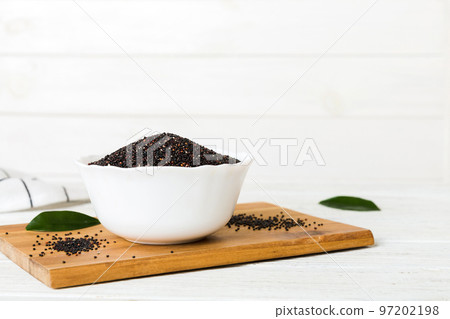 quinoa seeds in bowl on colored background. Healthy kinwa in small bowl. Healthy superfood quinoa seeds in bowl on colored background. Healthy kinwa in small bowl. Healthy superfood 97202198