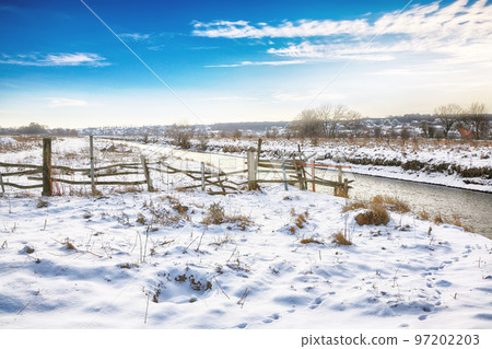 Winter landscape by a river during sunset 97202203