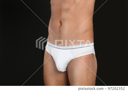 Man in underwear on black background, closeup Man in underwear on black background, closeup 97202352