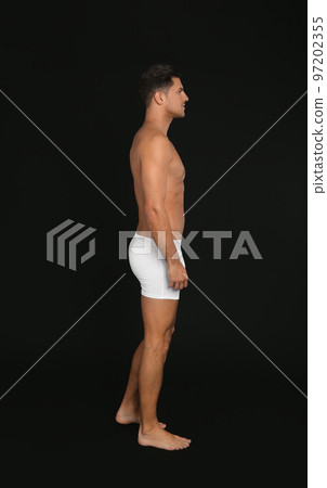 Handsome man in underwear on black background 97202355