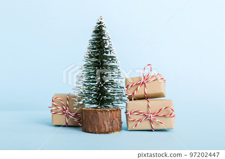 Christmas composition. Gifts, small tree, branches and craft DIY decorations on white background. New year concept. Christmas home decoration Flat lay, top view, copy space 97202447