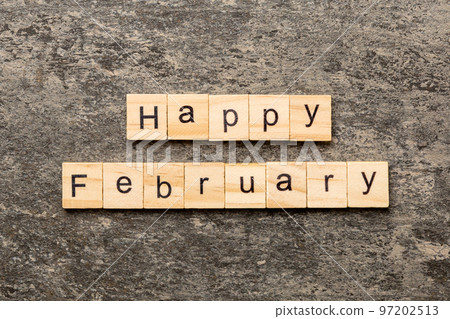 Happy February word written on wood block. Happy February text on table, concept 97202513