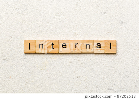 INTERNAL word written on wood block. INTERNAL text on cement table for your desing, concept INTERNAL word written on wood block. INTERNAL text on cement table for your desing, concept 97202518