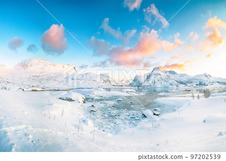 Fabulous frozen Flakstadpollen and Boosen fjords and reflection in water during sunrise with Hustinden mountain on background 97202539