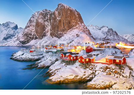 Amazing sunset winter view on Hamnoy village and Festhaeltinden mountain on background. 97202576