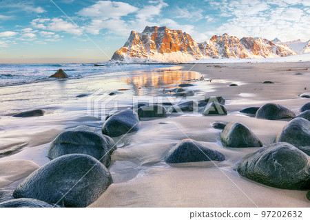 Astonishing winter scenery on Uttakleiv beach at sunset time. 97202632