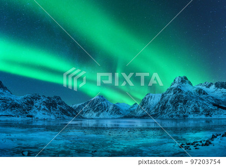 Aurora borealis over snowy mountains, frozen sea coast Aurora borealis over snowy mountains, frozen sea coast 97203754