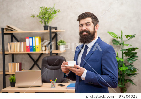 cheerful brutal ceo in businesslike suit hold morning coffee cup at the office, businessperson 97204025