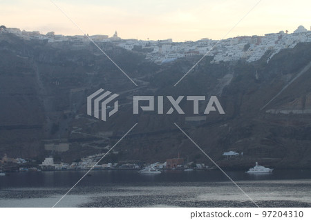 A row of white houses built on the cliffs of Santorini A row of white houses built on the cliffs of Santorini 97204310