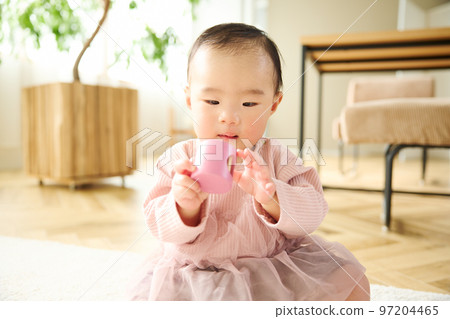 Baby playing in the living room Baby playing in the living room 97204465